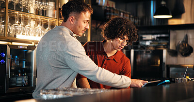 Buy stock photo Bar, waiter and manager with tech for order, teamwork and training of employee to review sales data. Pub, server and people with app to process transactions, conversation or help with system at night