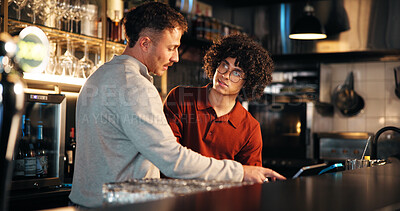 Buy stock photo Bar, waiter and teamwork with tech for order, manager and training of employee to review sales data. Pub, server and people with app to process transactions, conversation or help with system at night