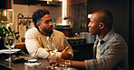 Friends, men and talking with wine in restaurant for social gathering, weekend break and hangout. Relax, people and alcoholic drinks with discussion in pub for happy hour, reunion event and bonding