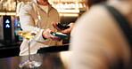 People, hands and pos machine with phone for payment, wireless transaction or easy banking in bar. Drink, customer or bartender with mobile smartphone or NFC for tap, EFT or ecommerce in restaurant