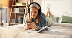 Happy, bed and woman with headphones and notebook for relaxing, writing in journal and social media. Bedroom, chill and person with phone listening to audio, radio and streaming music for inspiration