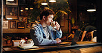 Drinking, coffee and man with laptop, cafe and remote work at night, copywriter and research on web. Working late, freelancer and person with tea in shop, thinking and tech for article or project