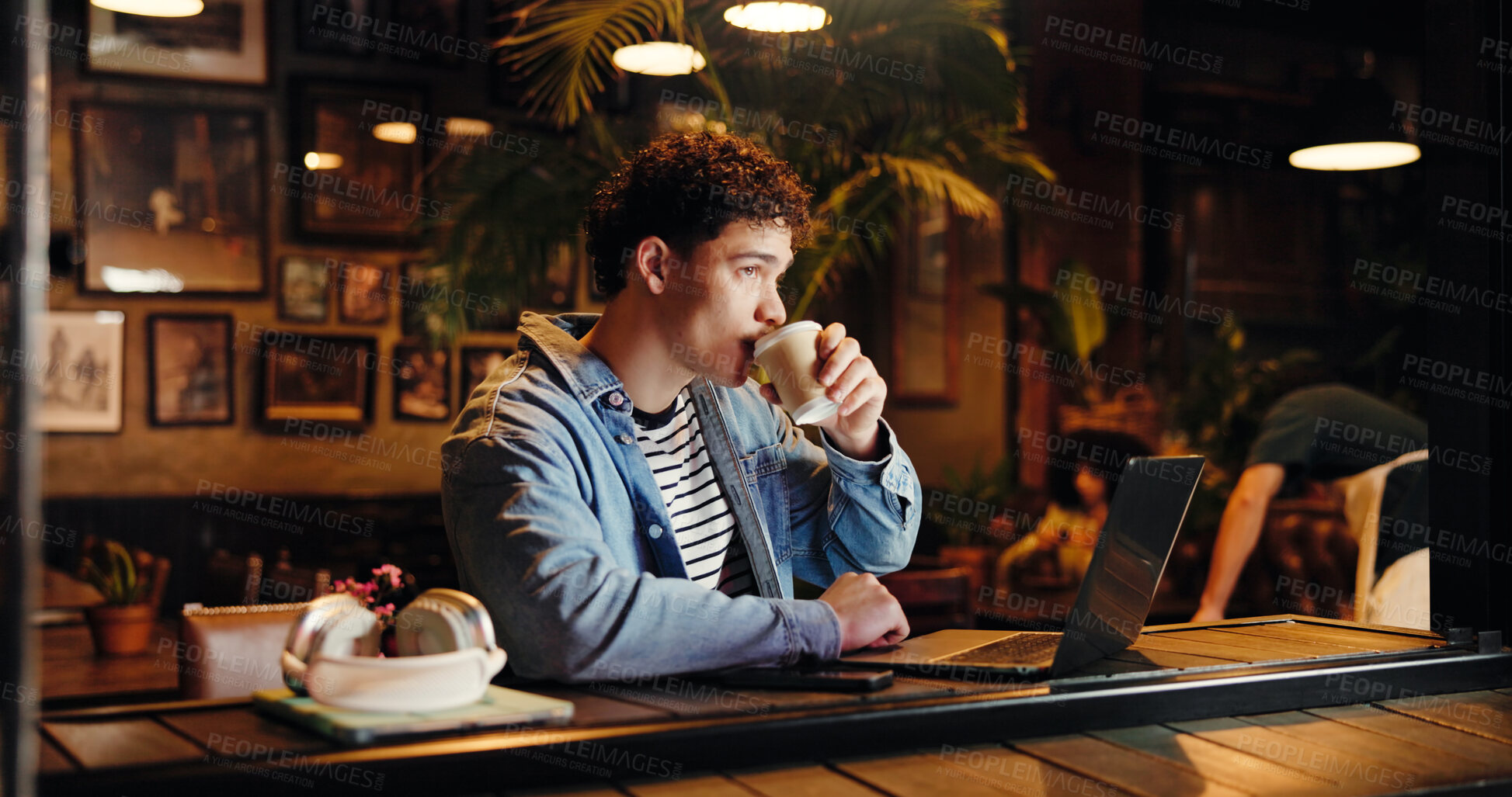 Buy stock photo Drinking, coffee and man with laptop, cafe and remote work at night, copywriter and research on web. Working late, freelancer and person with tea in shop, thinking and tech for article or project