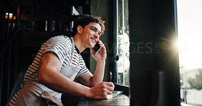 Buy stock photo Waiter, man and phone call at coffee shop with notes, contact supplier for deal, negotiation or order by window. Person, manager and listen with smartphone, smile and talk for stock discount at cafe