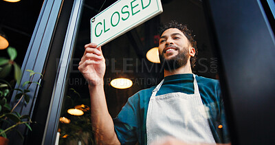 Buy stock photo Man, server and closed sign on cafe door for end of day, no service and message to customer. Below, male person and signage poster for information, restaurant notice and window with store reservation