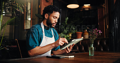 Buy stock photo Waiter, man and typing on tablet in cafe for stock order, email supplier and inventory management. Small business, manager and digital app in restaurant for menu planning and check sales performance