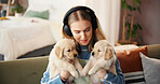 Headphones, woman and relax with puppies in home for bonding together, adoption or music playlist. Animal rescue, girl or listening to audio with labrador dogs for pet insurance or connection on sofa
