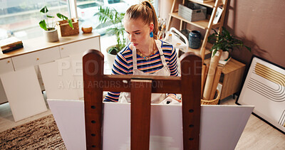 Buy stock photo Above, woman and artist painting on canvas for abstract art, design process and create artwork. Female person, easel and sketch drawing, crafts technique and diy creation of creative project at house