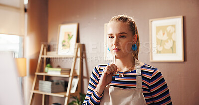 Buy stock photo Woman, painter and thinking with canvas, home studio and paint brush with perspective for artwork. Person, artist and tools with easel, inspiration and reflection with creative project at apartment