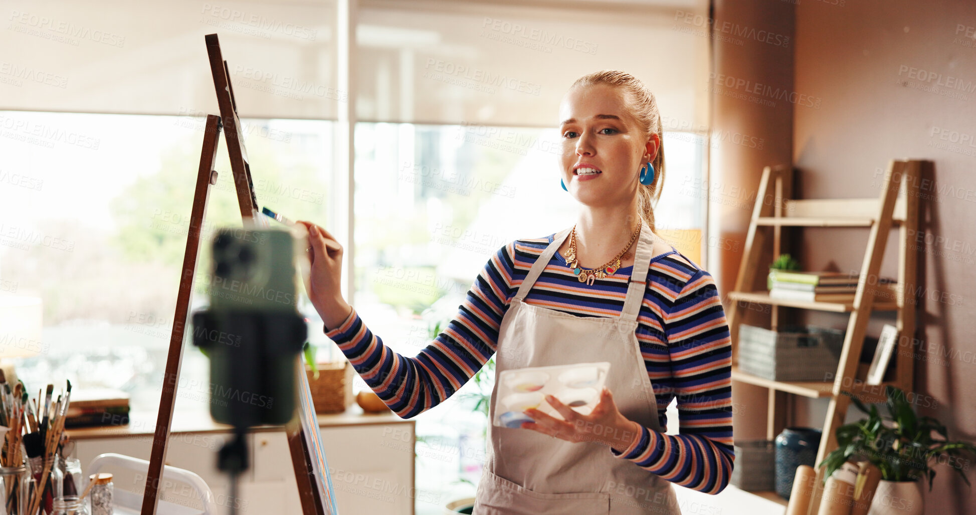 Buy stock photo Artist, canvas or phone for recording a video in home studio for painting process, advice or tips. Art influencer, girl or talking to fans on live stream to showcase craft, engagement or share skills