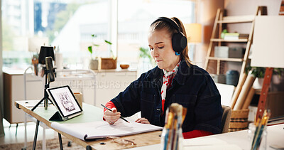 Buy stock photo Drawing, tablet and headphones with woman in studio for art reference, illustration or sketch pad. Streaming, talent and inspiration with person and notebook in workshop for artist and creative hobby