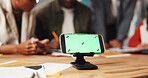 People, phone and green screen with stand for app advertising or marketing on office desk. Group, employees or mobile smartphone display for digital UI, web design or UX on mockup space in workplace
