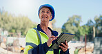 Architect, woman and tablet at construction site, typing and progress report for building project. Mature person, engineer and contractor with property expansion, tech and happy with app in Mexico