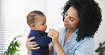 Mother, happy and playing with baby in home for bonding together, security and connection. Love, family and woman with infant affection for protection, morning routine and child development in house