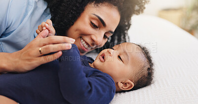 Buy stock photo Mother, happy and playing with baby on bed for bonding together, motherhood or connection. Security, family and woman relax with infant in home for protection, morning routine and child development