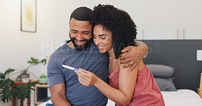 Buy stock photo Smile, couple and hug with pregnancy test at house of positive result, good news and IVF success. Happy, people and embrace for fertility kit, family planning and pregnant announcement of future baby
