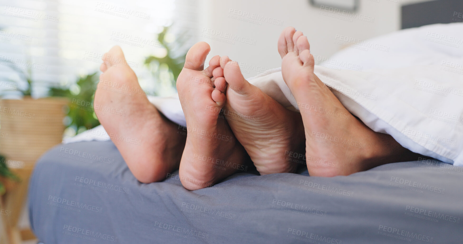 Buy stock photo Sleeping, couple and feet on bed, home or comfortable in bedroom, relationship or together on break. Barefoot, people and rest on mattress in house, relax and free time on weekend, legs and apartment