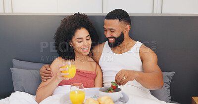 Buy stock photo Happy couple, relax and breakfast with orange juice or strawberries in bed for healthy diet in home. Man, woman or lovers with smile in bedroom for snack, nutrition or natural organic fruit in house