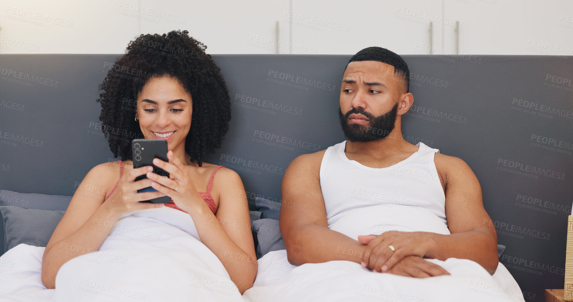 Buy stock photo Smile, woman and phone with suspicious man for lack of trust, cheating paranoia and insecurity. People, bed and mobile to spy on partner for secret chat, spouse infidelity and notification at house
