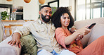 Happy couple, relax and watching tv with remote on sofa for movie, series or change channel in home. Man, woman or hug with comfort for news, subscription or online entertainment together in house