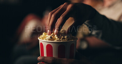 Buy stock photo Hands, popcorn and snack at cinema in crowd for film screening, fast food and event for entertainment. Person, eating and relax for show, movies or container with audience at night in theater