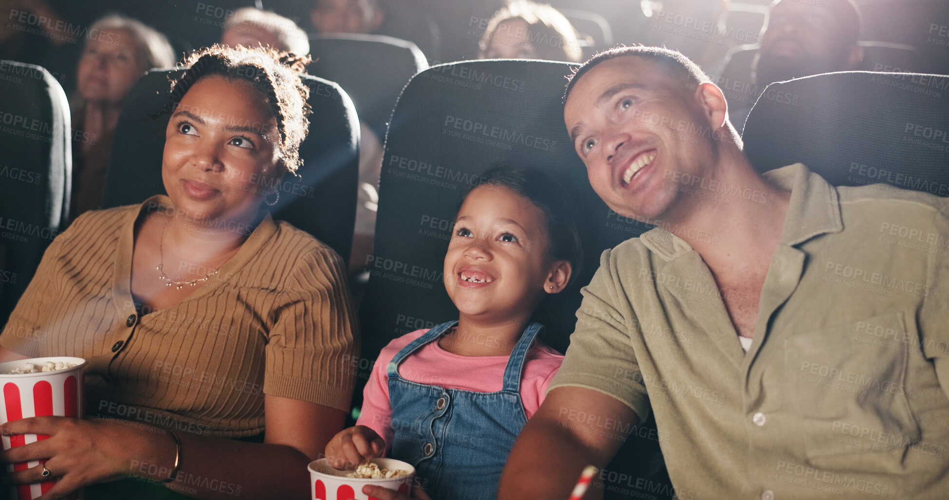 Buy stock photo Family movie, theatre and child with popcorn in cinema for entertainment, experience and watching cartoon. Happy, parents and girl with snacks for screening, animation or film audience for production
