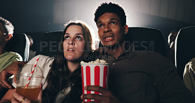 Buy stock photo Couple, popcorn and horror movie at cinema with snack, date and entertainment at film screening. People, man and woman with shock for thriller in crowd, spooky show and scared with fear at theater