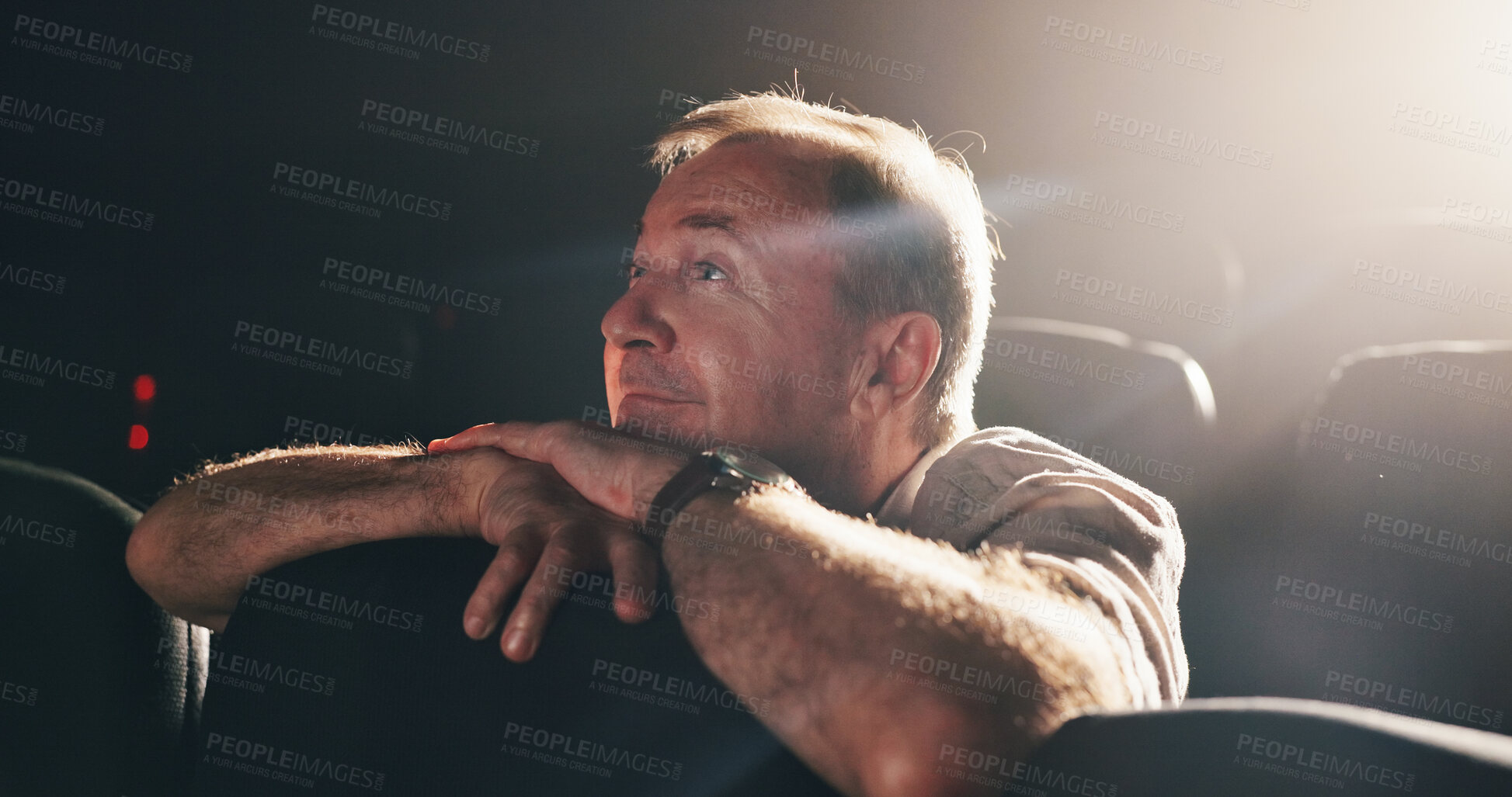 Buy stock photo Cinema, thinking and watching movie with senior man, memory and nostalgia with lights. Pensioner, retirement and elderly person with break, entertainment and night with empty seats and theater