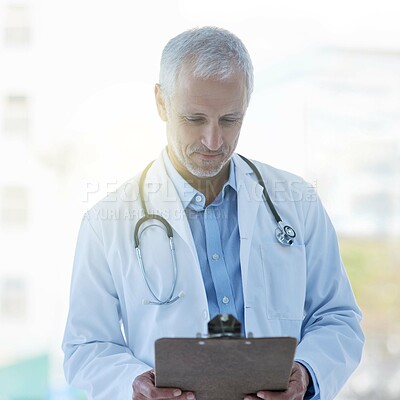 Buy stock photo Doctor, clipboard and stethoscope in hospital for medical research, examination or consultation with records. Physician, male person and mature at health, chart and results for healthcare or medicine