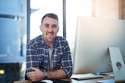 Buy stock photo Portrait of a happy young businessman working at his office desk