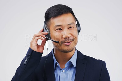 Buy stock photo Asian man, business and call center in studio with talking, headset and happy on white background. Male person, consultant and advisor for support, information and crm with mic for communication