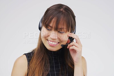 Buy stock photo Asian woman, smile and headset in studio on white background for consultant, call centre and crm. Female person, happy and headphones with mic for customer support, connectivity and communication