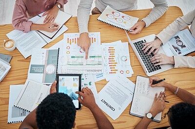 Meeting, planning and finance with a group or team of business people discussing data, a contract or financial report from above. Overhead of a boardroom meeting for strategy, growth and development