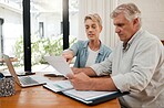 Retirement couple budget, finance and investment planning, loan and paper bills for online banking at home. Senior man, woman and people reading tax money report, cash savings and admin document note