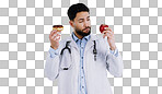Healthy, diet and doctor with choice of food, apple or donut  in hands for nutrition in studio white background. Nutritionist, thinking and man with a decision for health with fruit and dessert