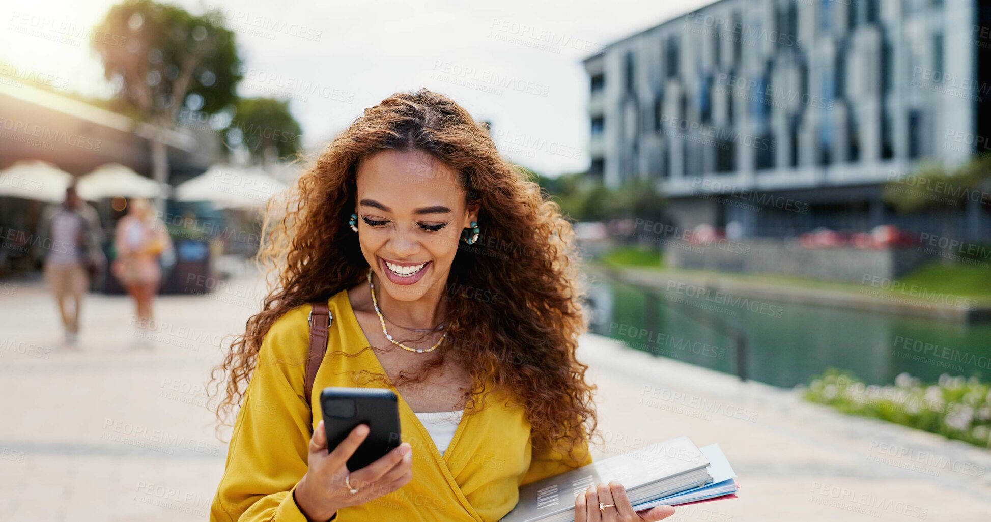 Buy stock photo Education, phone and smile with student woman on campus of college or university for learning. Books, funny and social media with happy person outdoor at school for growth, scholarship or study