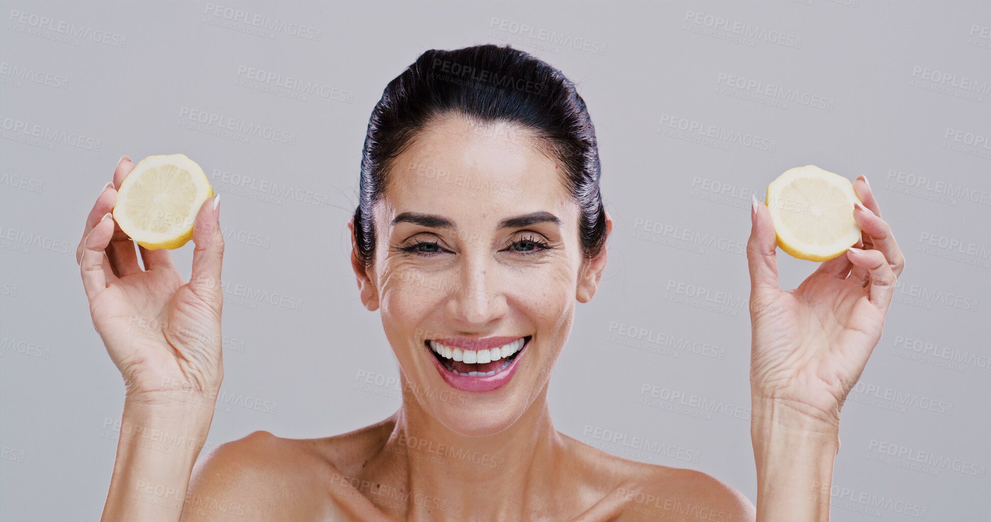 Buy stock photo Portrait, lemon and woman with skincare, smile and dermatology on gray studio background. Mature person, organic cosmetics and model with confidence, citrus and natural detox with wellness and facial