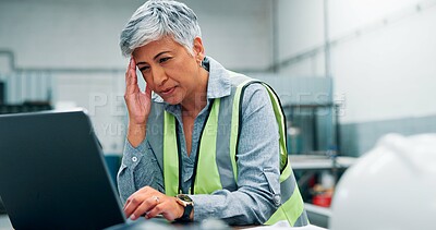 Buy stock photo Engineer, laptop and stress with woman in workshop for manufacturing, problem solving or production. Computer, design process and headache with mature employee in factory for tech development