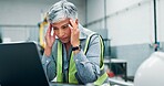 Mature, woman and laptop with headache in workshop for engineering fatigue, burnout and website 404. Technical glitch, robotics software error and migraine for stress, crisis or disaster in lab