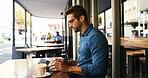Customer, man and typing on tablet at cafe for online research, coffee break and remote work. Freelancer, person and scroll on digital app at bistro for networking, email response and check schedule