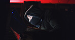 Technology, hacker and person with mask at night for coding scam, phishing or cybercrime in office. Anonymous, privacy and programmer with security breach on technology for database in control room.