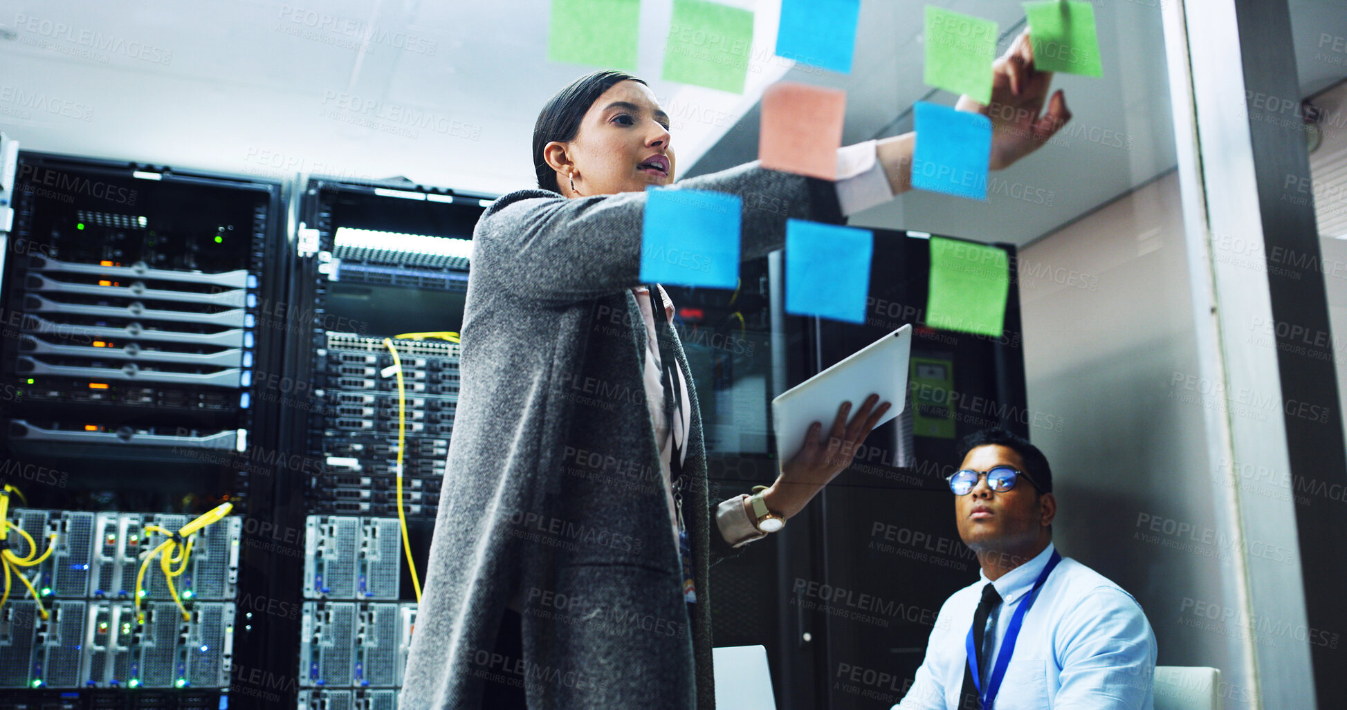 Buy stock photo People, IT engineer and planning with sticky note in server room for priority on network security. Technician, team or cybersecurity agency brainstorming with tablet for troubleshooting in datacenter