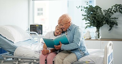 Buy stock photo Senior woman, girl and reading book on hospital bed with hug, happy and bonding for recovery. Child, grandmother and smile with literature, story and embrace for rehabilitation at pediatric clinic