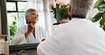 Woman, brush and mirror in home with makeup, concealer and cosmetics in bedroom. Mature person, getting ready and smile in reflection for skincare, beauty procedure and powdering skin at vanity table
