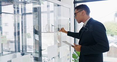 Buy stock photo Businessman, tablet and sticky note for finance, agenda or brainstorming in office for strategy. Glass wall, employee and technology with report, feedback or schedule tasks for investment project