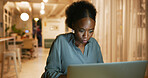 Employee, night and black woman with laptop, online reading and review for news report. African person, evening and journalist in office, pc and magazine editor with article, check facts and research