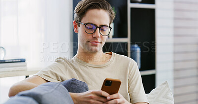 Buy stock photo Home, relax and man on couch, cellphone and typing with social media, connection and message to contact. Apartment, mobile user and person on sofa, smartphone and internet with digital app or texting
