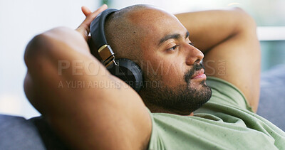 Buy stock photo Relax, headphones and peace with man on sofa for streaming service, calm audio and ambient sound. Guided podcast, white noise and playlist with person in living room of home for break and radio