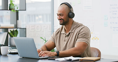 Buy stock photo Laptop, headphones and man typing in office with music, playlist or podcast for working on creative project. Audio tech, computer and person streaming album for article with publishing at agency.