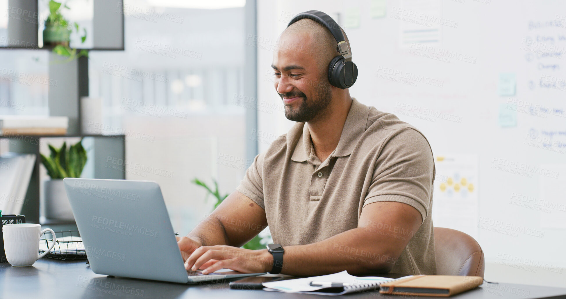 Buy stock photo Laptop, headphones and man typing in office with music, playlist or podcast for working on creative project. Audio tech, computer and person streaming album for article with publishing at agency.